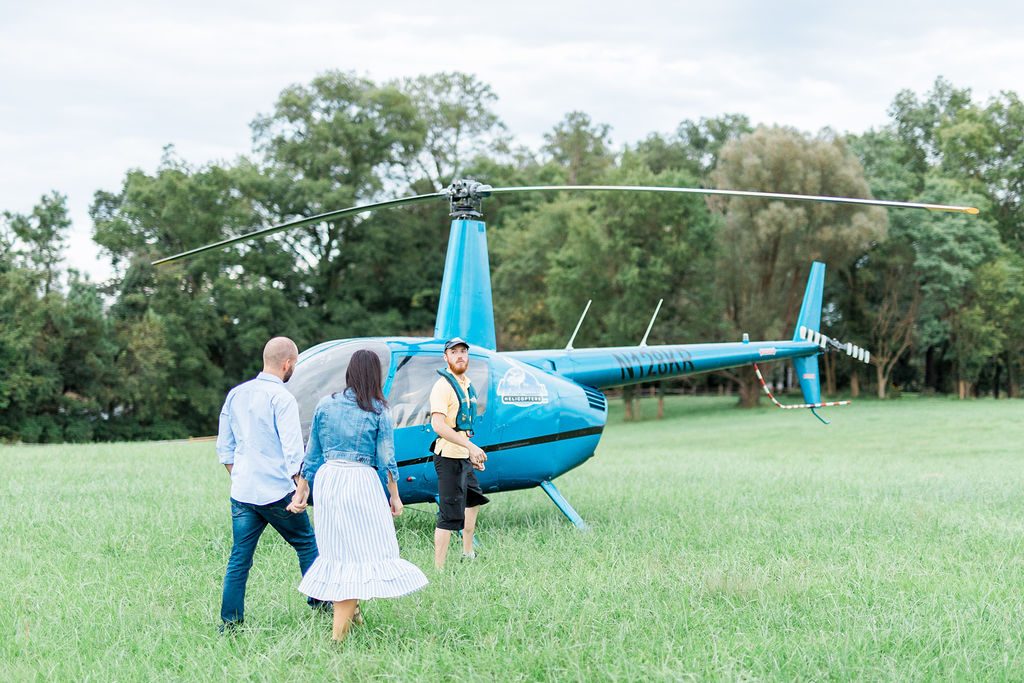 Couple approaching helicopter